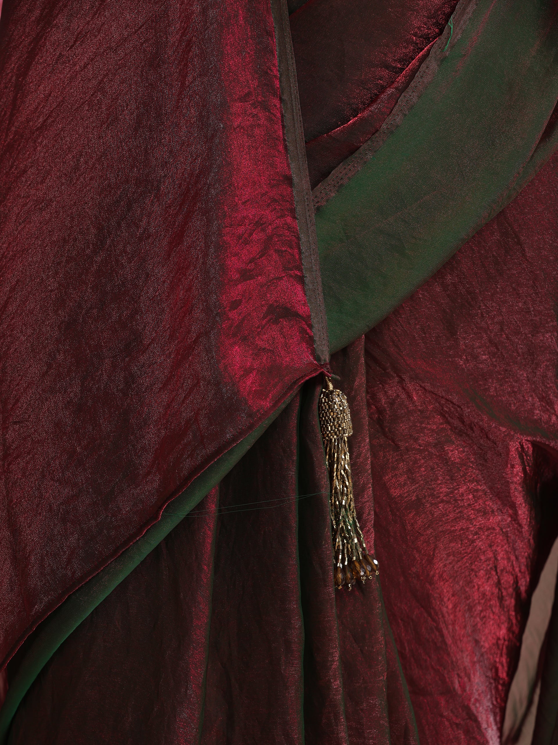 Enigmatic Elegance Saree – Dual-Shade Maroon-Green Metallic Satin with Pendants & Self Blouse Fabric