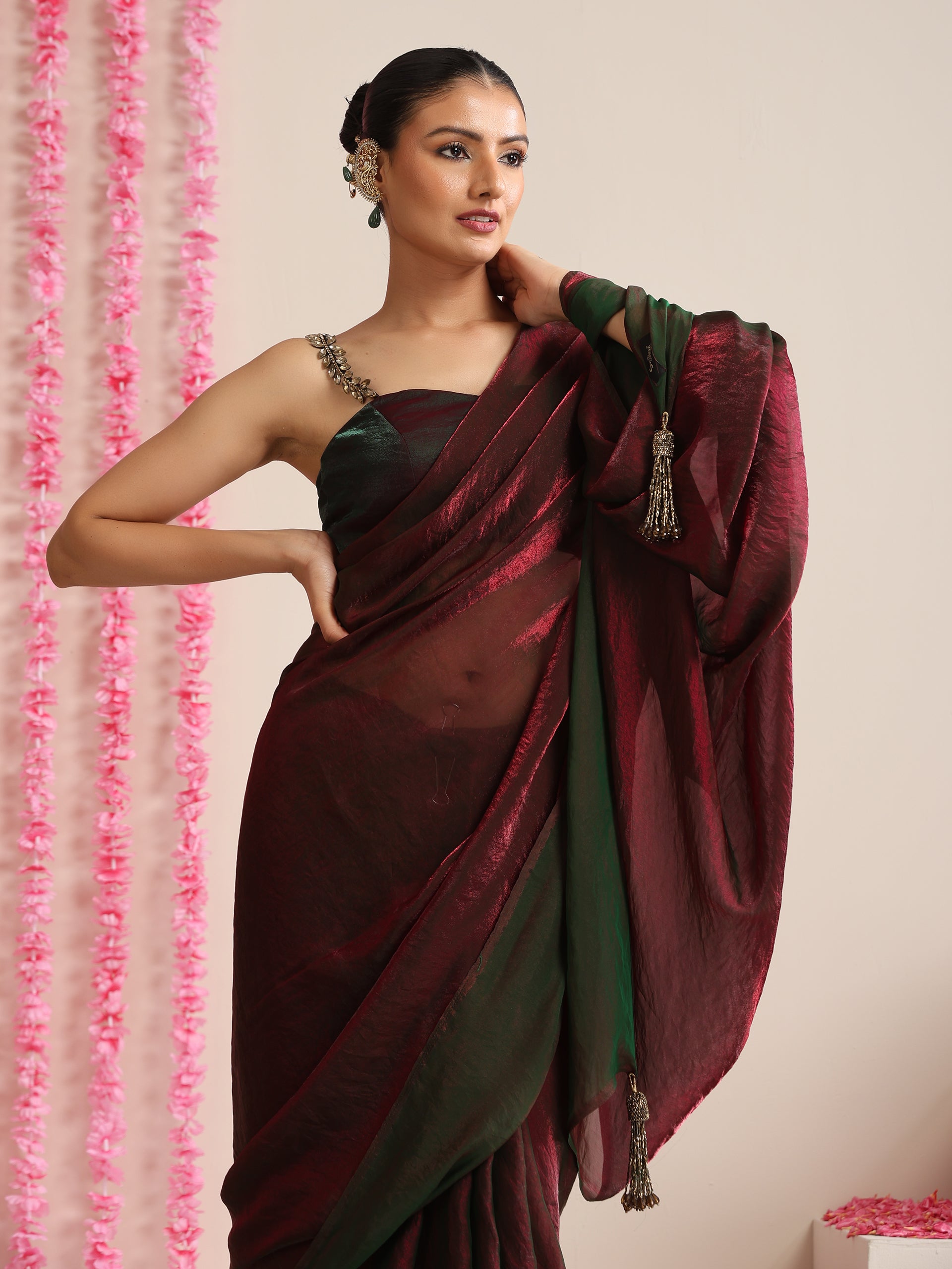 Enigmatic Elegance Saree – Dual-Shade Maroon-Green Metallic Satin with Pendants & Self Blouse Fabric