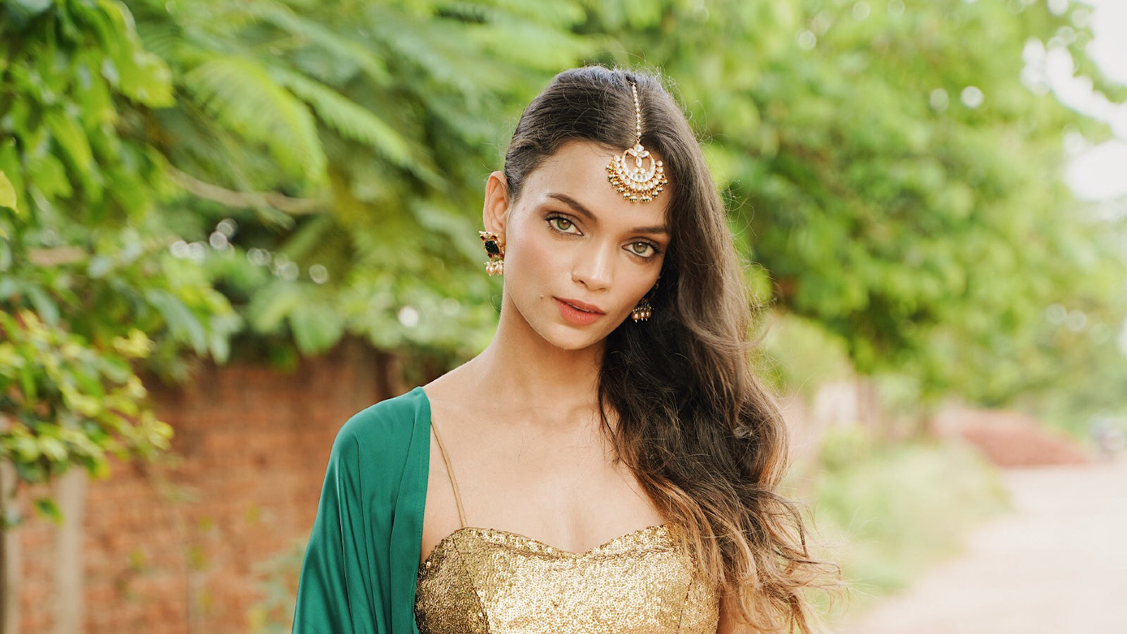 Emerald green satin saree with gold sequin blouse