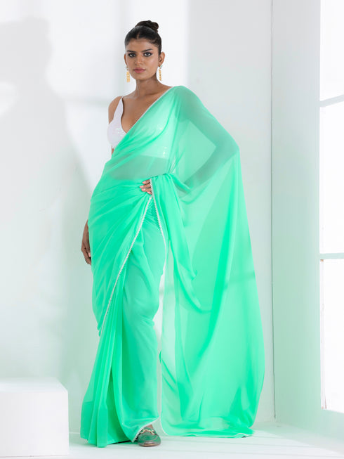 Summer Breeze Green Georgette Saree with Edge Lace and Irridecent Blouse Fabric