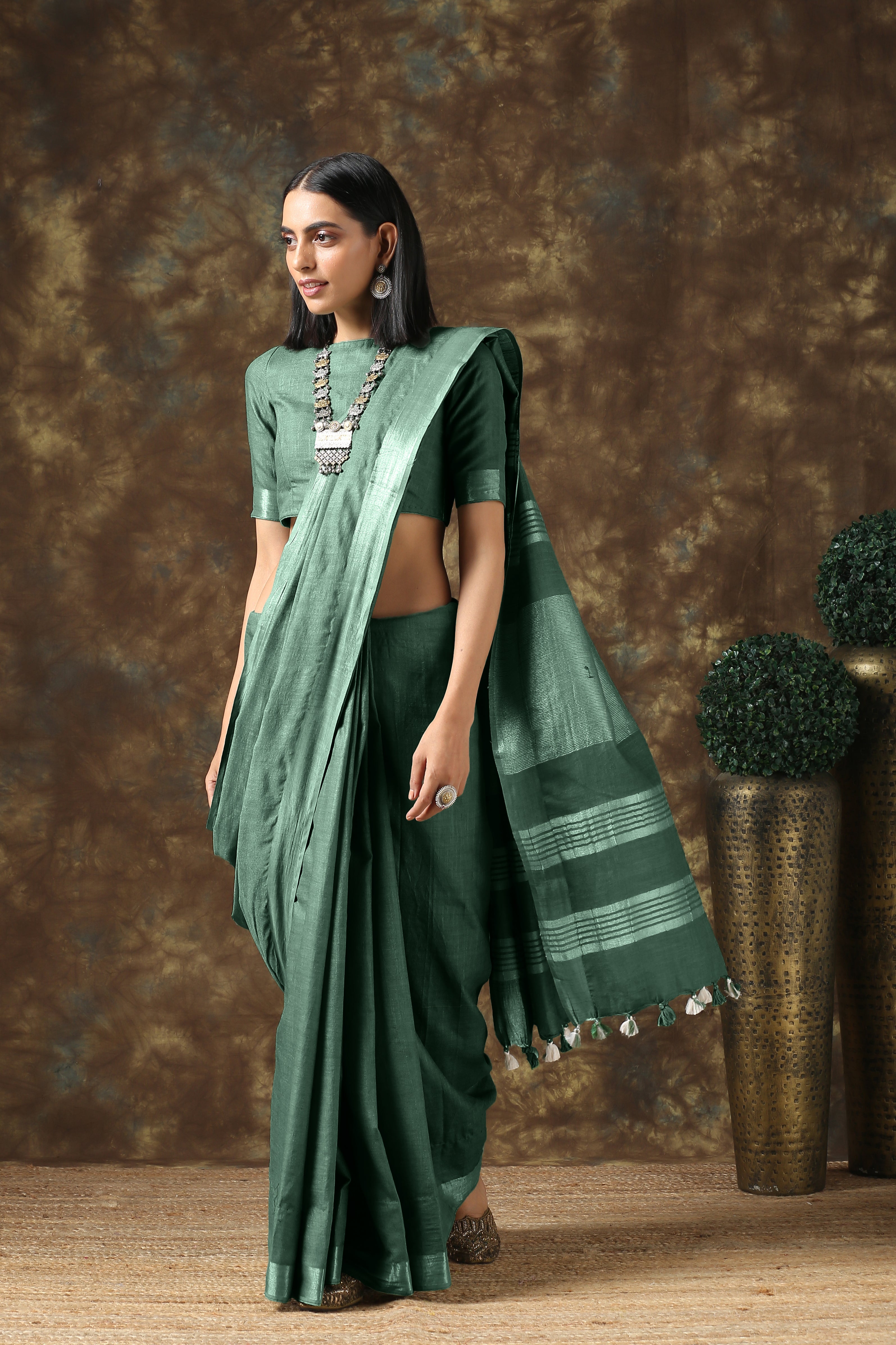 Opulent olive linen saree with silver border and blouse