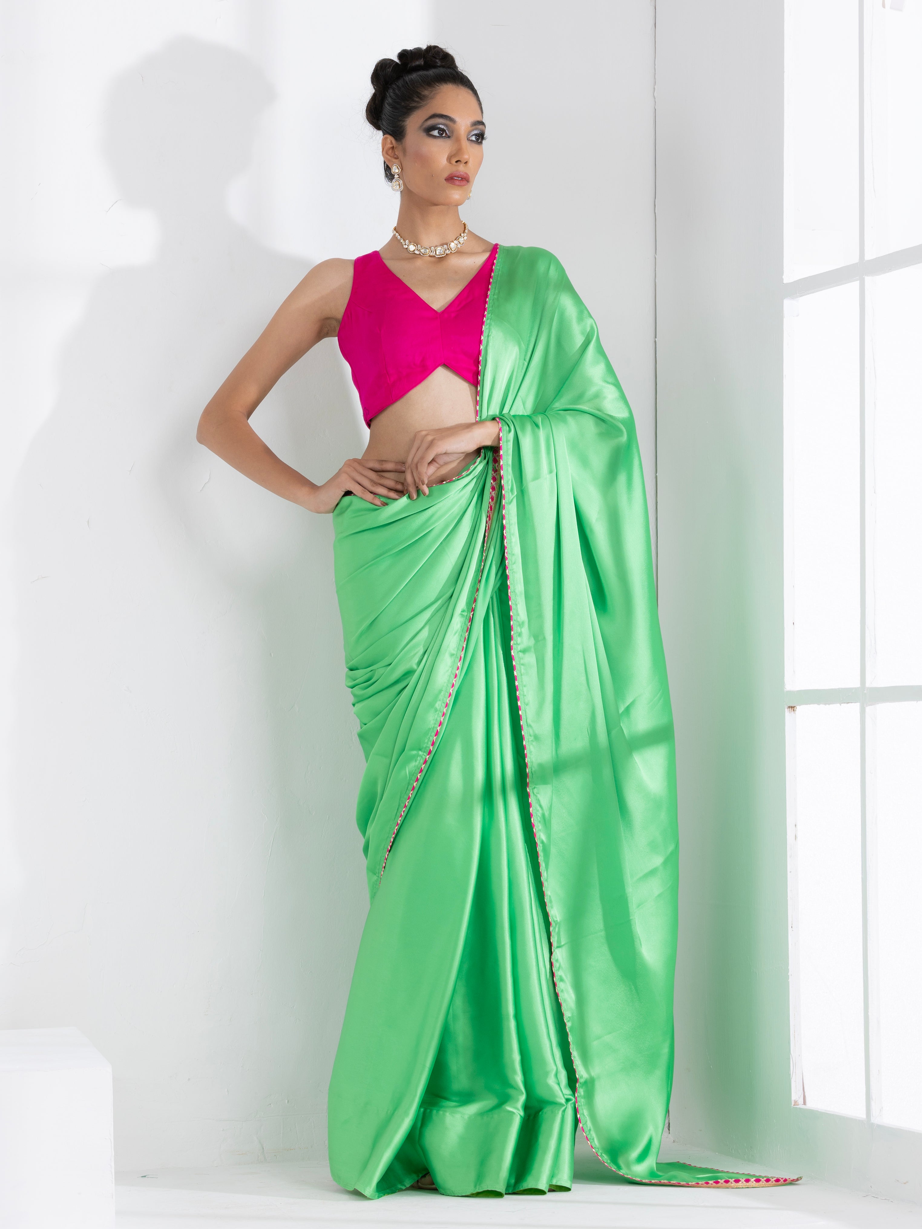 Rich Emerald Green Satin Saree with Bronze Pendants